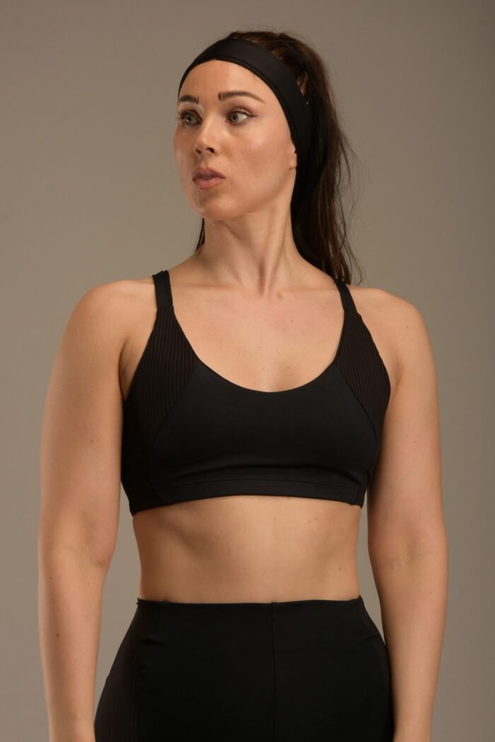 Women's black sports top with thin straps and ribbon details